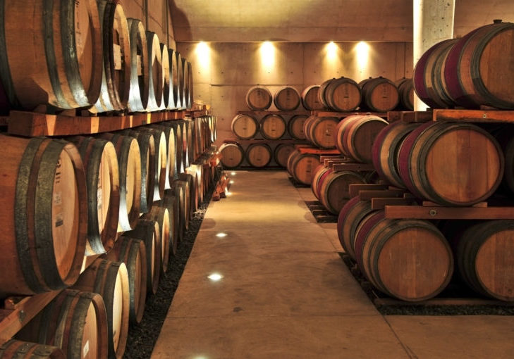 Stacked oak wine barrels in winery cellar